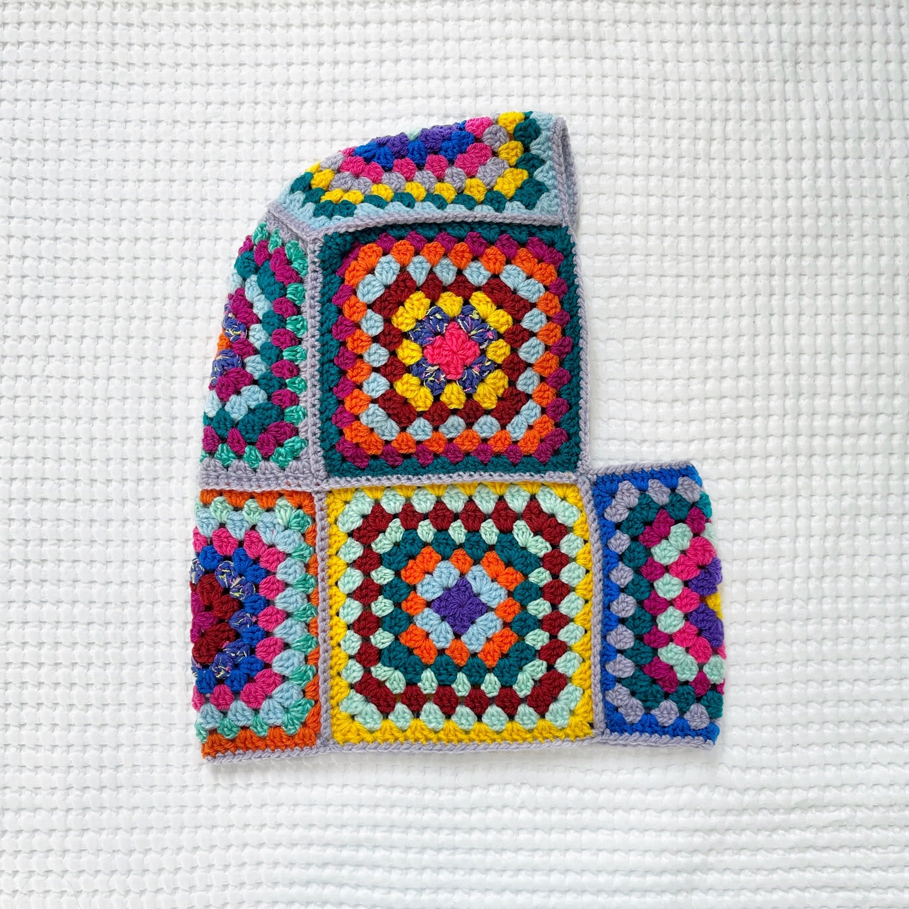 Colorful crocheted balaclava on a white background