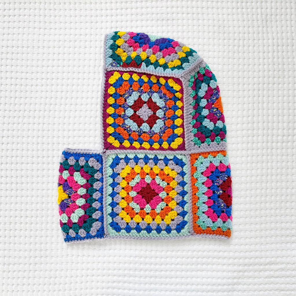 Colorful crocheted balaclava on a white background