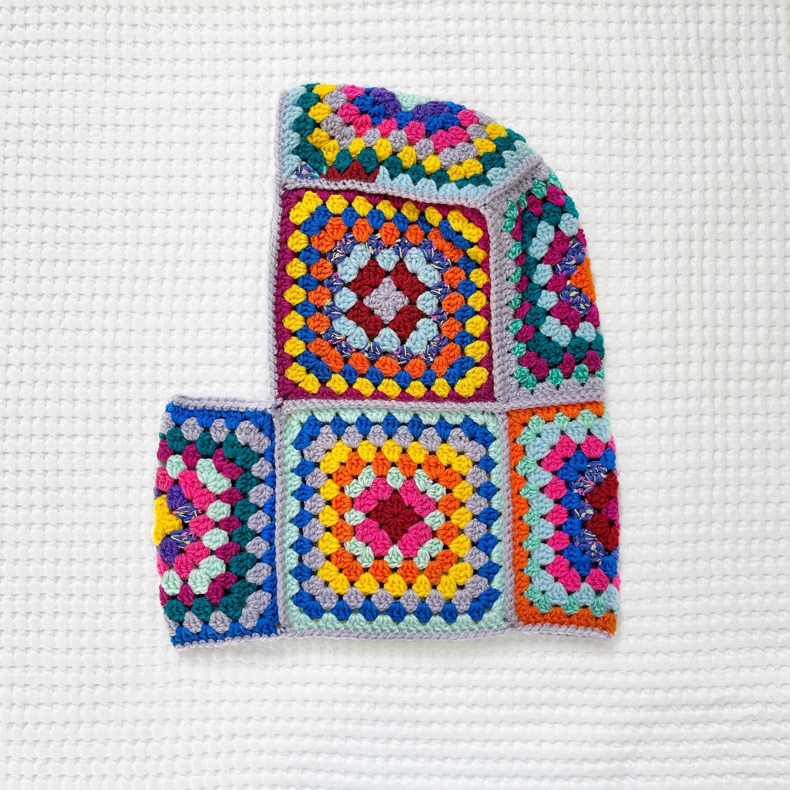 Colorful crocheted balaclava on a white background