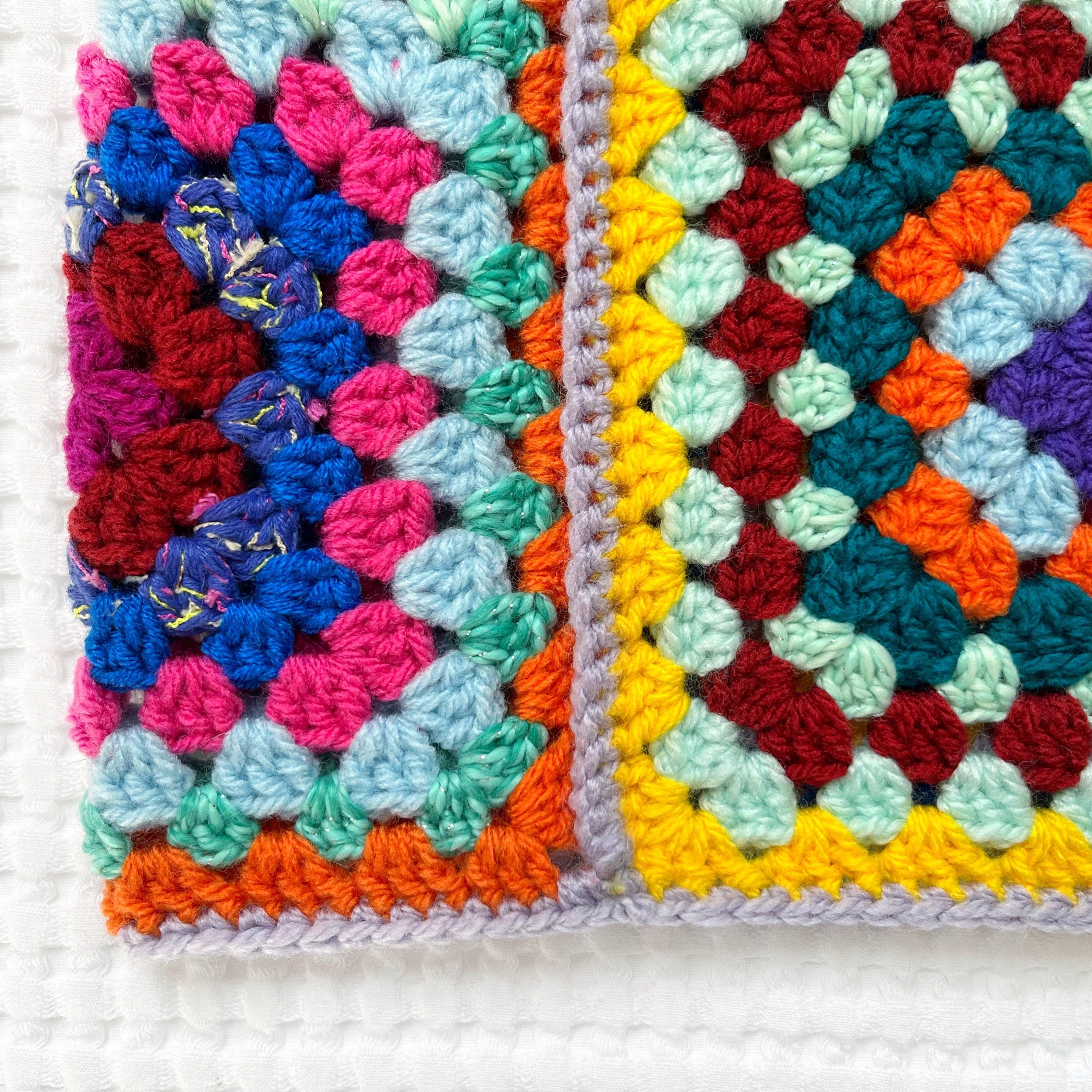 Colorful crocheted balaclava on a white background
