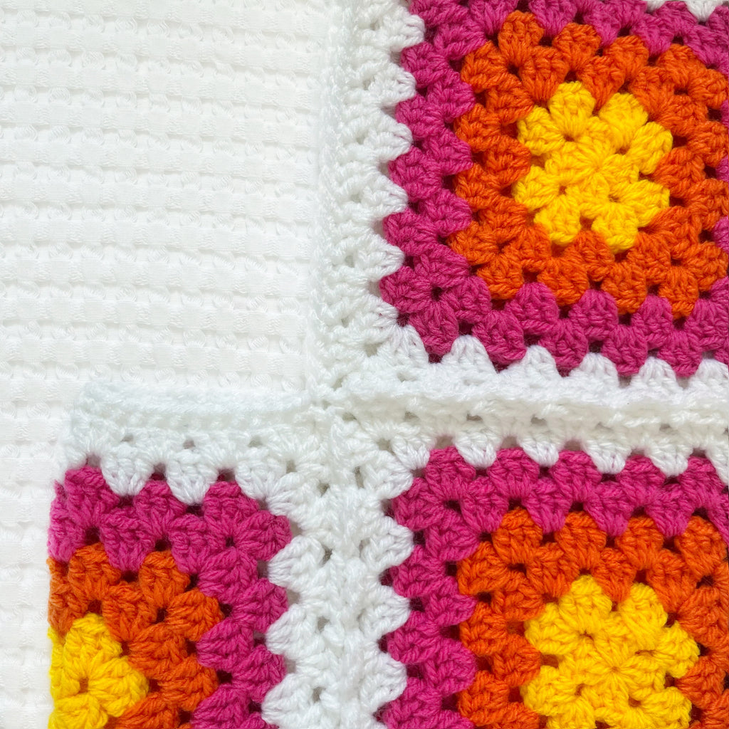 Colorful crocheted balaclava on a white background