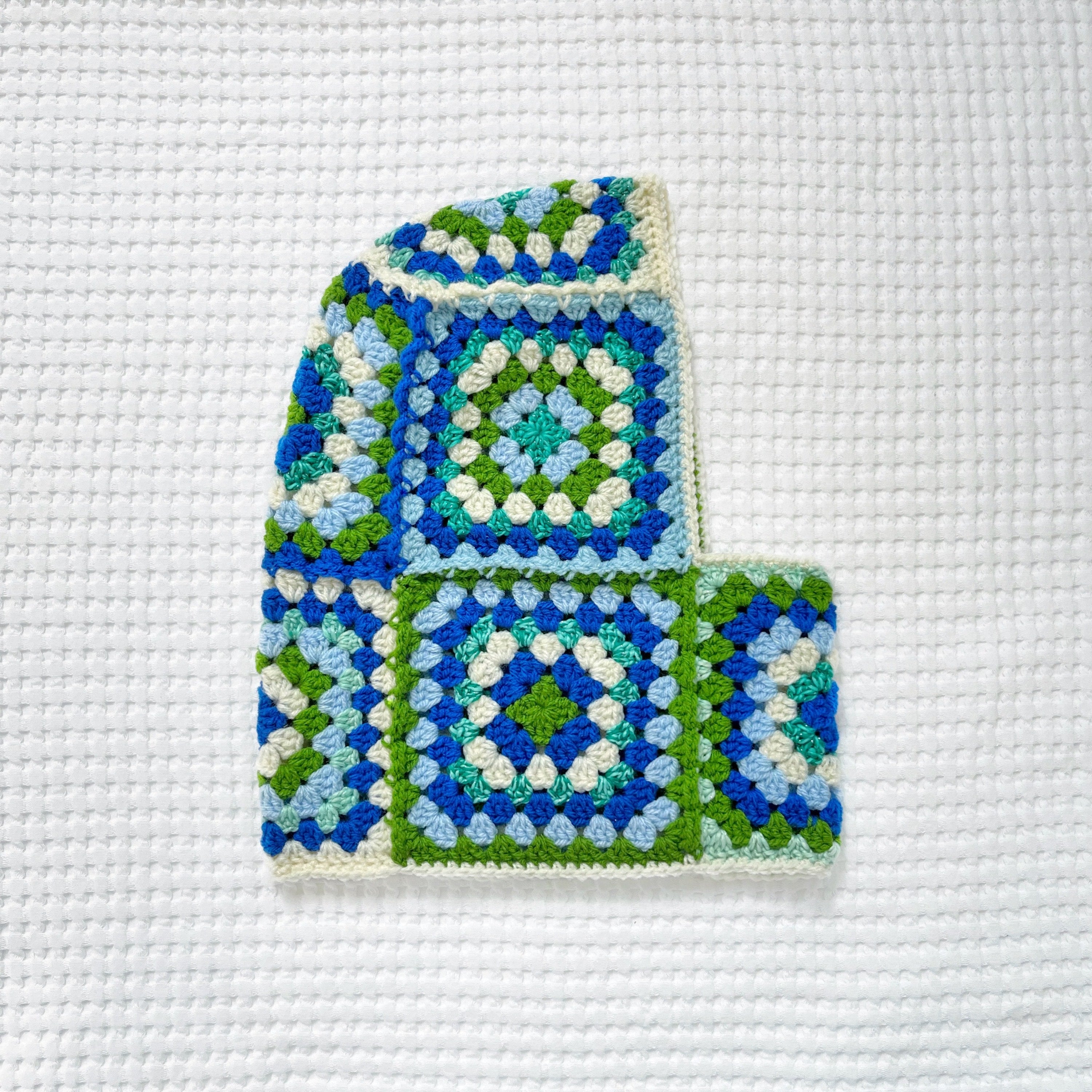 Crocheted balaclava on a white fabric background