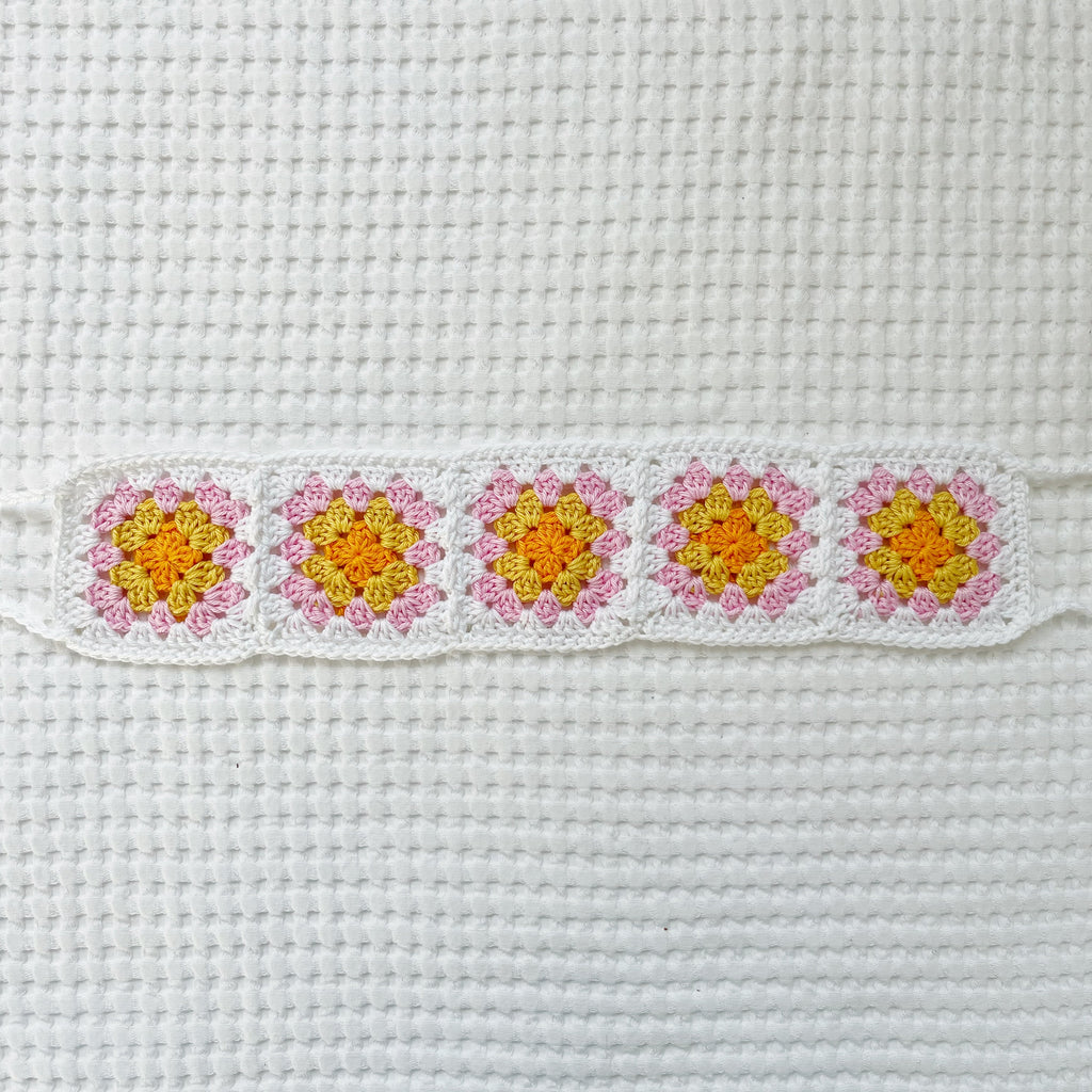 Crocheted headband on a white fabric background