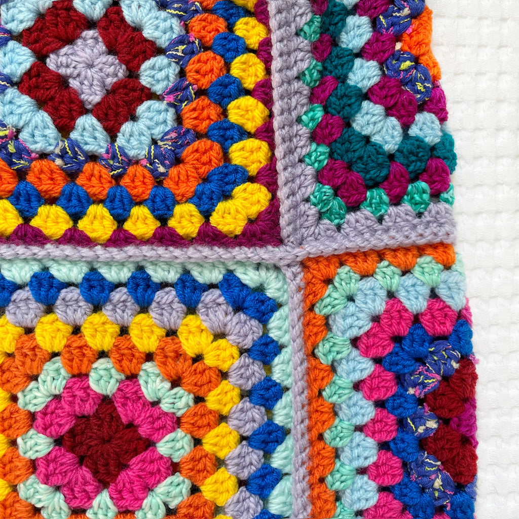 Colorful crocheted bbalaclava on a white background