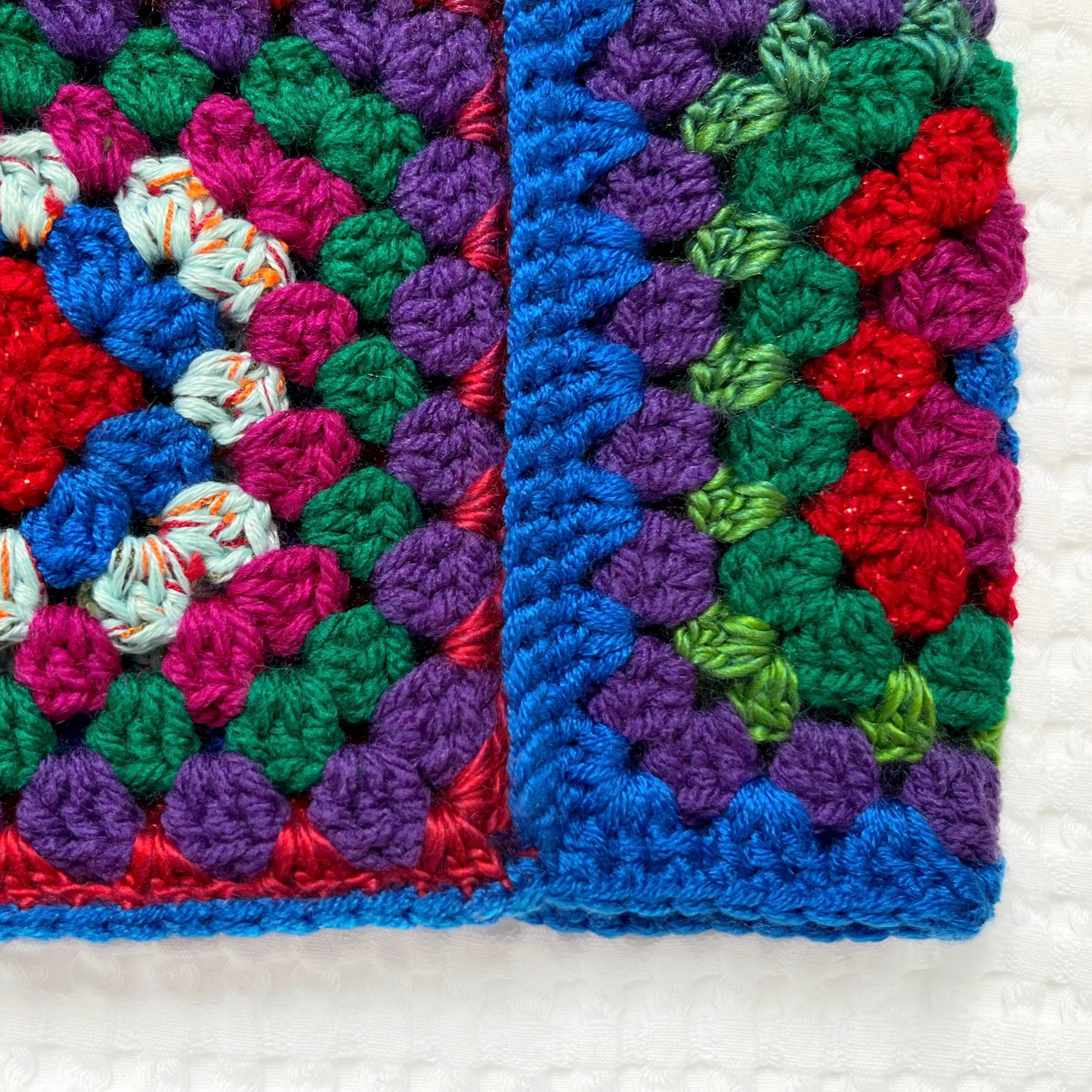 Colorful crocheted balaclava with a geometric pattern on a white background