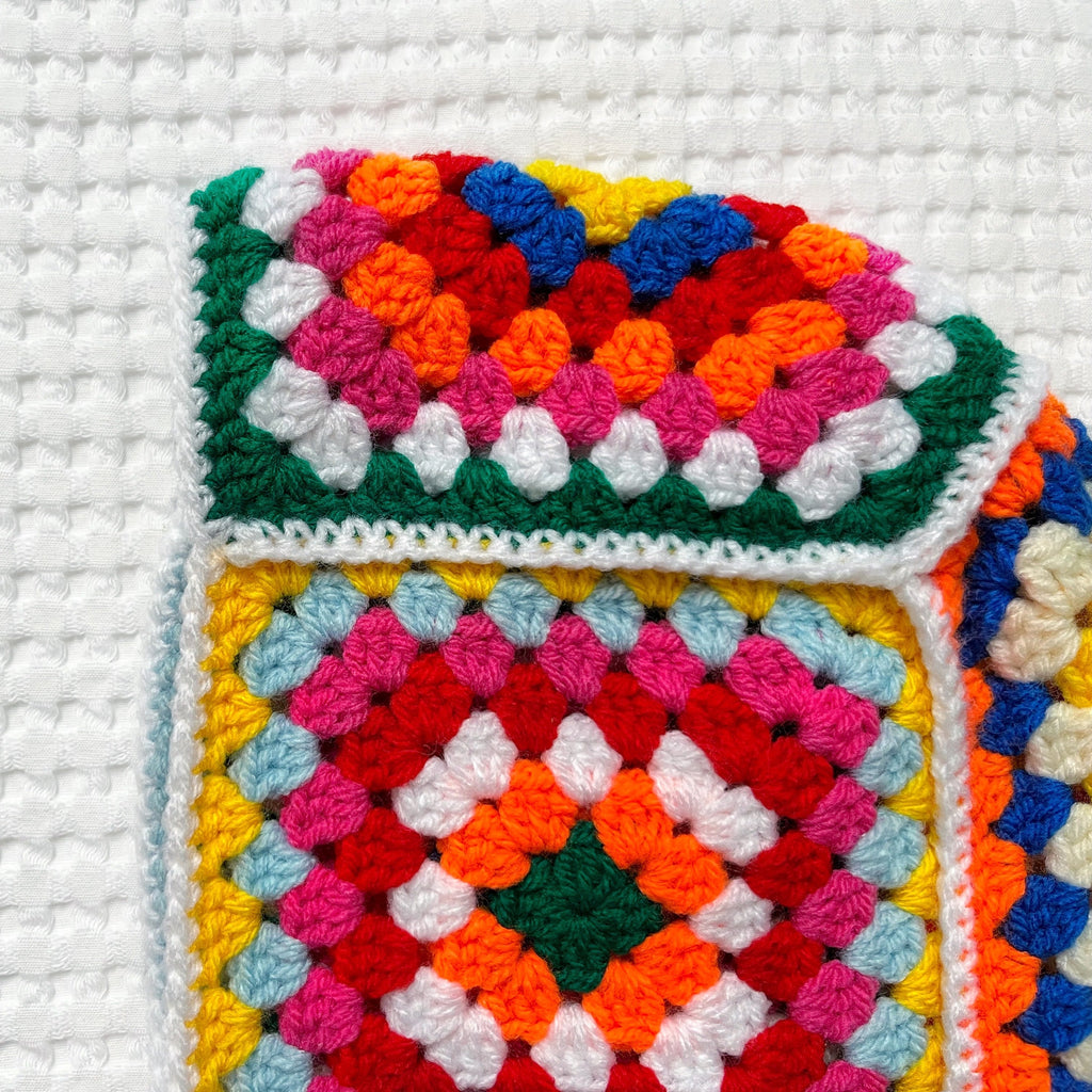 Colorful crocheted balaclava on a white background