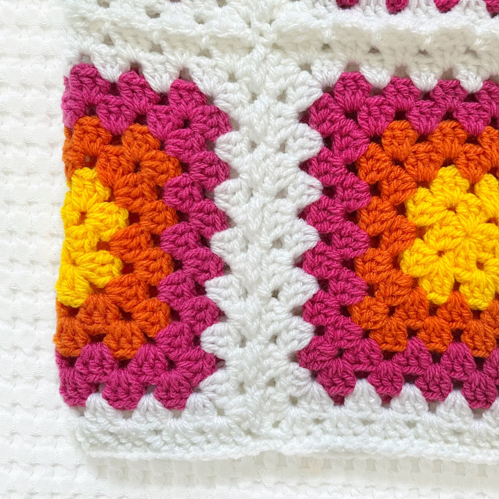Colorful crocheted balaclava on a white background