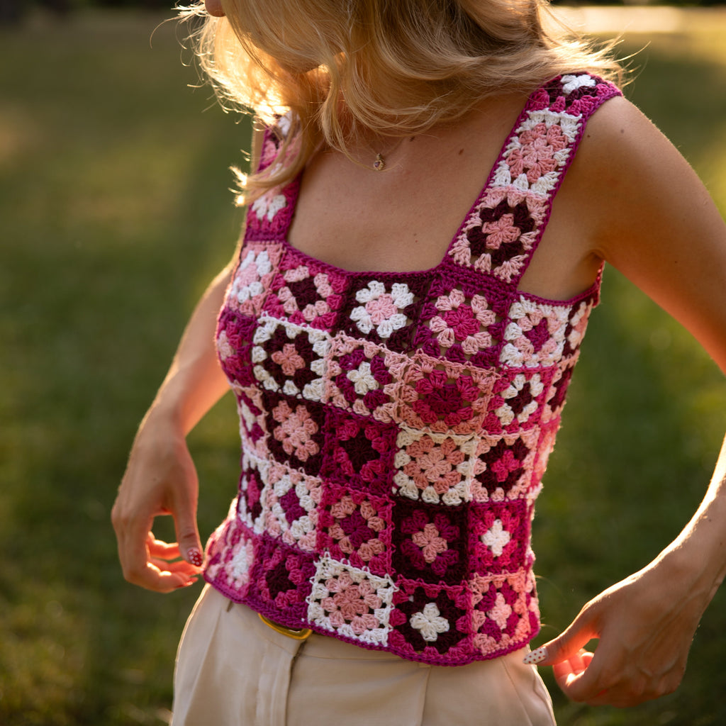 Woman wearing a colorful crochet tank top outdoors