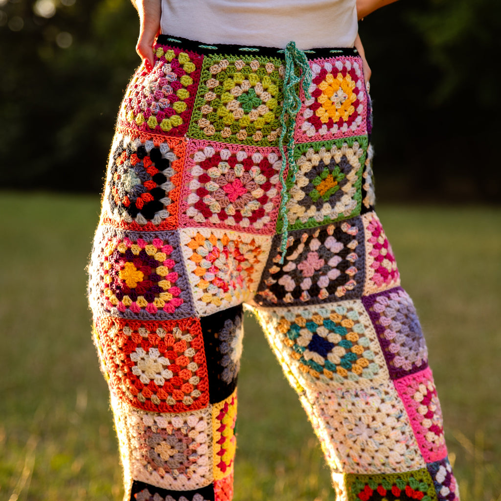 Colorful crochet pants worn by a person in an outdoor setting