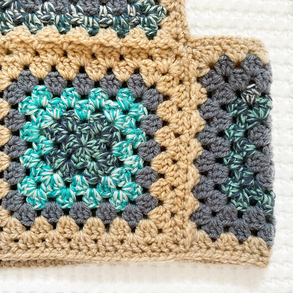 Crocheted balaclava with a square pattern on a textured white background