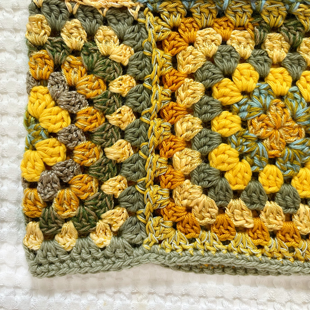 Crocheted balaclava on a textured white background