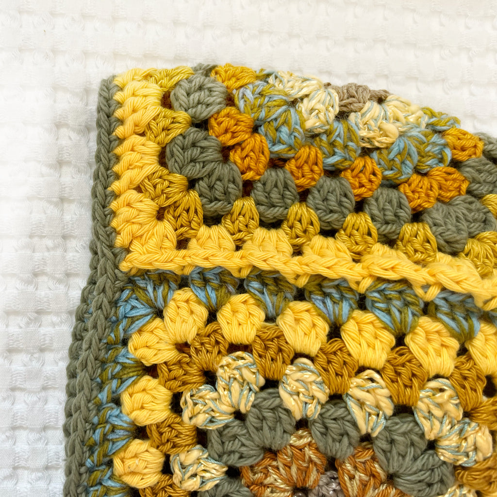 Crocheted balaclava on a textured white background